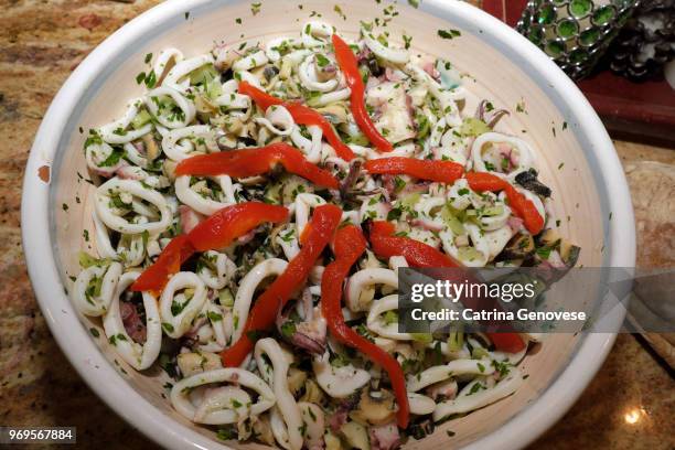 seafood salad with italian bread on the side served on christmas eve as part of the feast of the seven fishes. - side salad fotografías e imágenes de stock