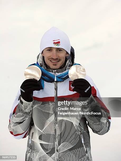 Adam Malysz of Poland presents his silver medals of the normal hill and large hill competions at the Olympic Winter Games Vancouver 2010 biathlon on...