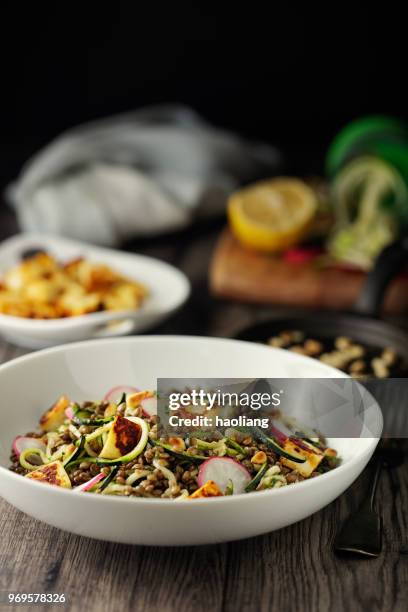 healthy lentil and courgette noodles salad with grilled halloumi cheese cubes - haoliang stock pictures, royalty-free photos & images