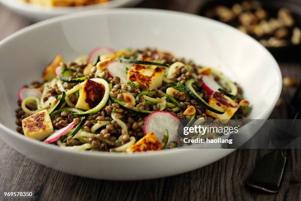 healthy lentil and courgette noodles salad with grilled halloumi cheese cubes - haoliang stock pictures, royalty-free photos & images