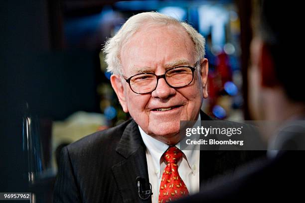 Warren Buffett, chief executive officer of Berkshire Hathaway, speaks during a television interview in advance of a charity lunch with a group led by...