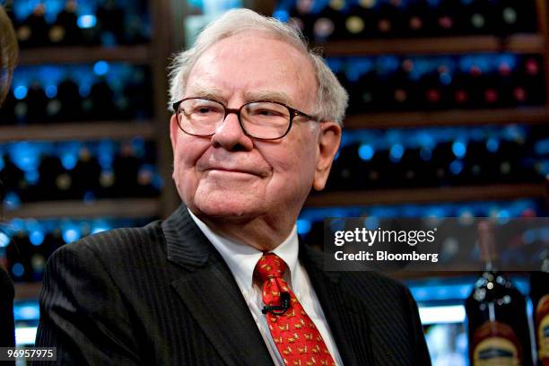 Warren Buffett, chief executive officer of Berkshire Hathaway, pauses during a television interview in advance of a charity lunch with a group led by...