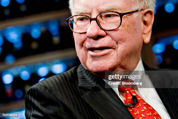 Warren Buffett, chief executive officer of Berkshire Hathaway, speaks during a television interview in advance of a charity lunch with a group led by...