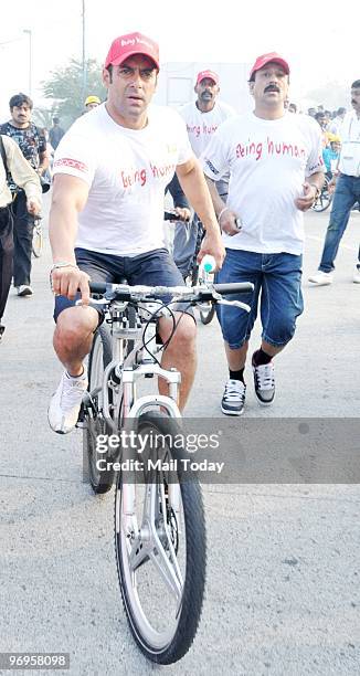 Bollywood actor Salman Khan rides a bicycle before the start of the inaugural Tour de Mumbai Cyclothon in Mumbai on February 21, 2010.