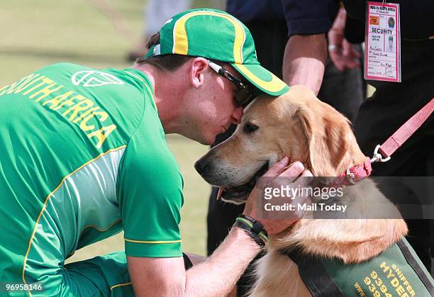 South African pacer Dale Steyn shows his affection to a sniffer dog in Jaipur on Feb. 21, 2010. India won the match.