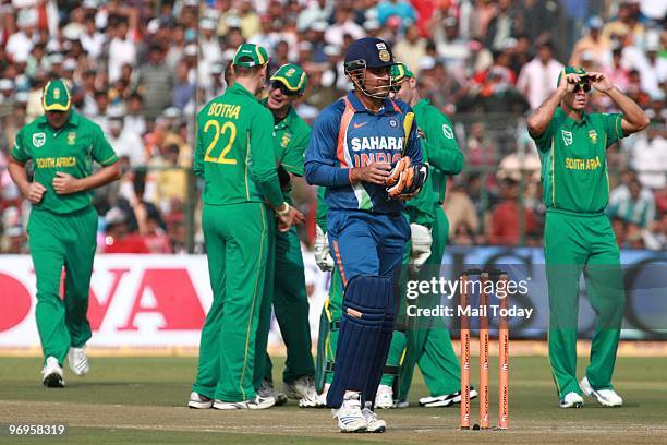South African players stand after the dismissal of India's Virender Sehwag during the one day international cricket match between India and South...