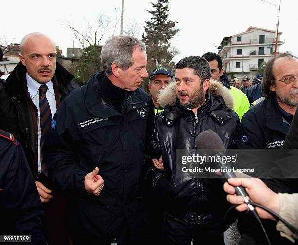 Head of civil protection, Guido Bertolaso speaks with Bruno Rizzo Mayor of Maierato during a visit to Maierato on February 22 near Reggio Calabria,...