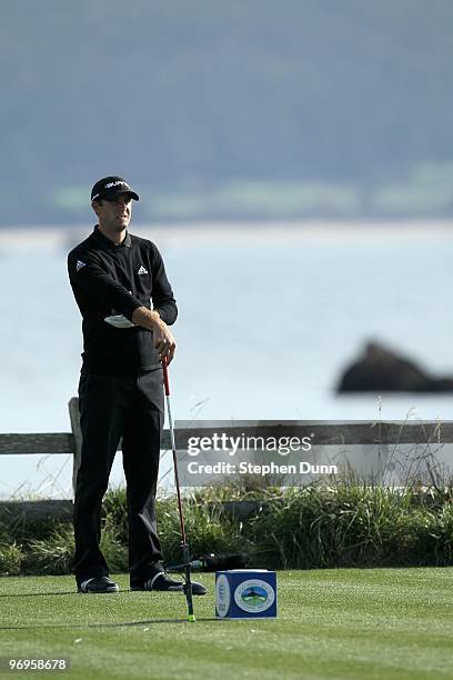 Dustin Johnson waits to hit his tee shot on the 18th hole during the first round of the AT&T Pebble Beach National Pro-Am at Pebble Beach Golf Links...