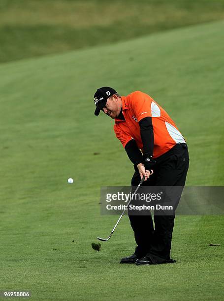 Holmes pitches to the sixth green during the first round of the AT&T Pebble Beach National Pro-Am at Pebble Beach Golf Links on February 11, 2010 in...