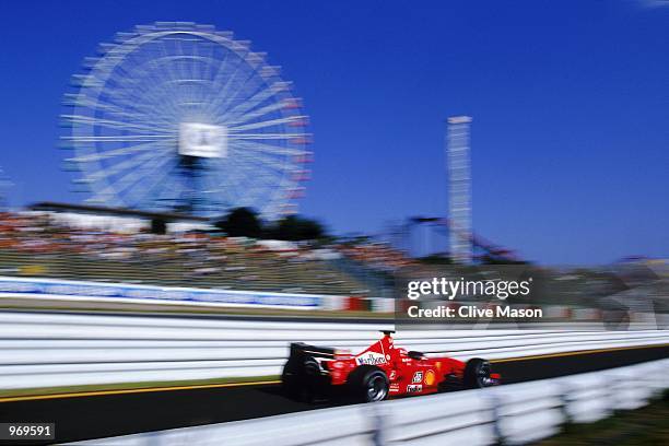 Ferrari driver Michael Schumacher of Germany puts his car through its paces during the Formula One Japanese Grand Prix held at the Suzuka Circuit in...