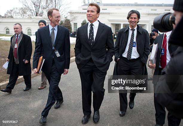 Arnold Schwarzenegger, governor of California, center, leaves the White House after speaking to the media in Washington, D.C., U.S. On Monday, Feb....