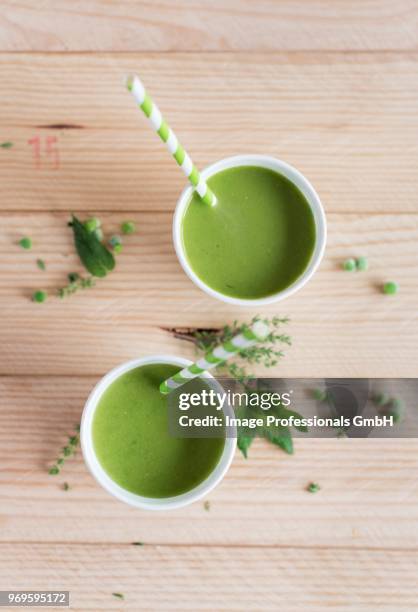 cups of cold pea soup - pea soup stock pictures, royalty-free photos & images