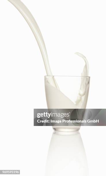 pouring milk into a glass - milk stream stock pictures, royalty-free photos & images