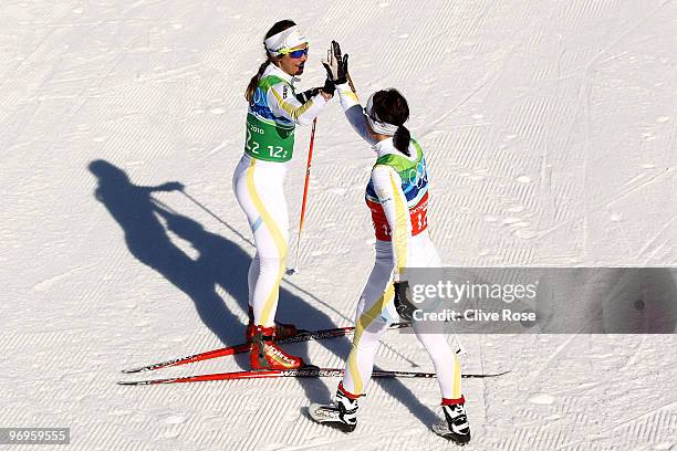 Anna Haag and Charlotte Kalla of Sweden compete during the cross country skiing ladies team sprint semifinal on day 11 of the 2010 Vancouver Winter...