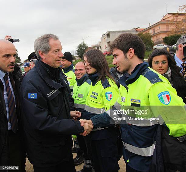 Head of civil protection, Guido Bertolaso, greets a man of civil protection during his visit in the town of Maierato on February 22 near Reggio...