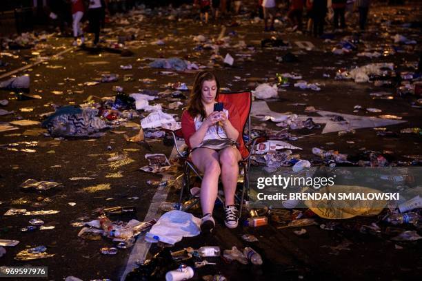 Washington Capitols fan sits in the street near the Capitol One Arena after fans celebrated the hockey team's Stanley Cup win over the Las Vegas...