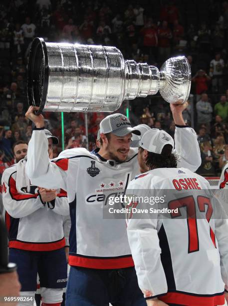 Jay Beagle of the Washington Capitals takes the Stanley Cup from teammate T.J. Oshie after Game Five of the 2018 NHL Stanley Cup Final between the...