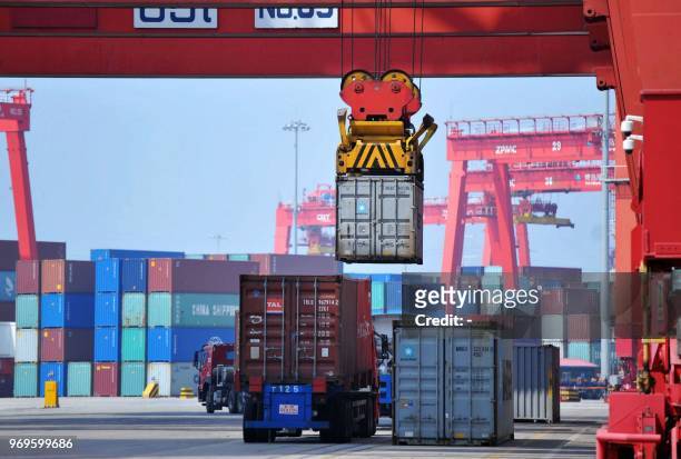 Container is transferred at a port in Qingdao in China's eastern Shandong province on June 8, 2018. China's trade surplus with the United States...
