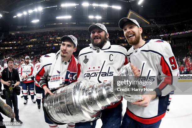 Dmitry Orlov, Alex Ovechkin and Evgeny Kuznetsov of the Washington Capitals pose for a photo with the Stanley Cup after their team defeated the Vegas...