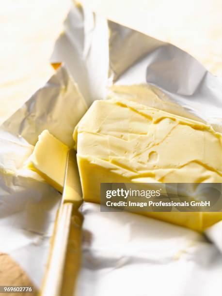 slab of butter and knife - butter curl stock pictures, royalty-free photos & images