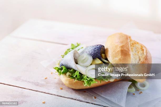 baguette with bismarck herring, gherkins, lettuce and onions - curly endive stock pictures, royalty-free photos & images