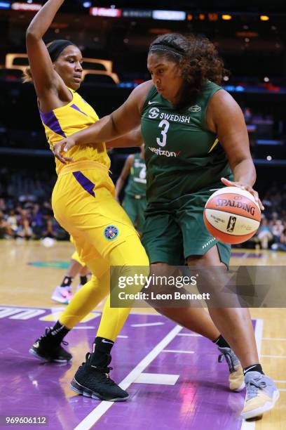 Courtney Paris of the Seattle Storm handle the ball against Jantel Lavender of the Los Angeles Sparks during WNBA basketball game at Staples Center...