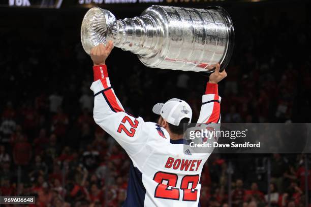Madison Bowey of the Washington Capitals hoists the Stanley Cup after Game Five of the 2018 NHL Stanley Cup Final between the Washington Capitals and...