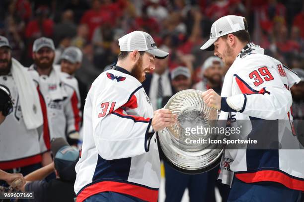 Washington Capitals Right Wing Alex Chiasson hands the Stanley Cup to Washington Capitals Goalie Philipp Grubauer after defeating the Las Vegas...