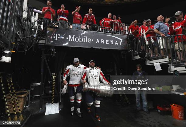 Tom Wilson, left, and Alex Ovechkin of the Washington Capitals walk with the Stanley Cup after Game Five of the 2018 NHL Stanley Cup Final between...