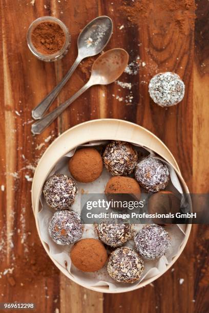 date energy balls rolled in cocoa powder and desiccated coconut - coconut shaving stock pictures, royalty-free photos & images