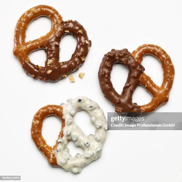 three pretzels dipped in white and dark chocolate - chocolate dipped stock pictures, royalty-free photos & images