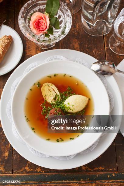 beef broth with three different toppings: liver dumpling, semolina dumpling and a shredded pancake - beef liver stock pictures, royalty-free photos & images