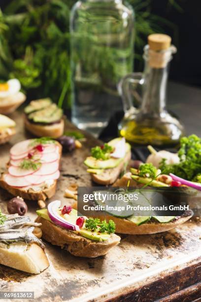 bruschetta with various toppings on a rustic table - toppings stock pictures, royalty-free photos & images