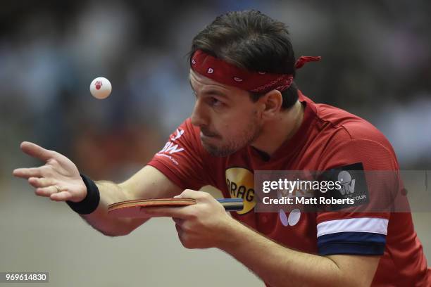 Timo Boll of Germany competes against Yuta Tanaka of Japan during the men's singles round one match on day one of the ITTF World Tour LION Japan Open...