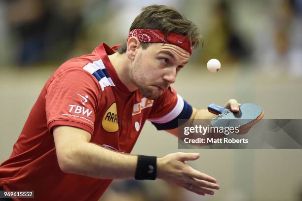 Timo Boll of Germany competes against Yuta Tanaka of Japan during the men's singles round one match on day one of the ITTF World Tour LION Japan Open...