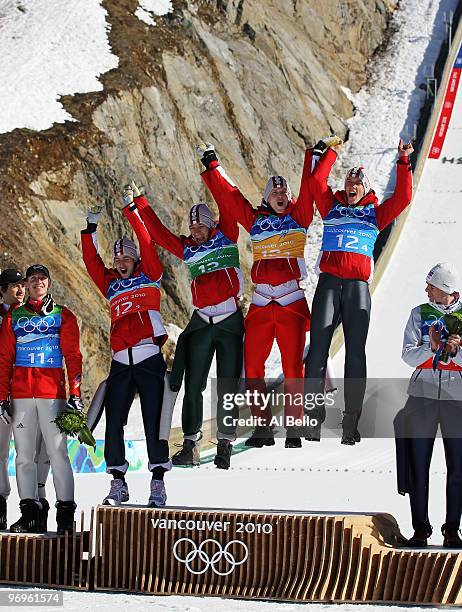 Wolfgang Loitzl, Andreas Kofler, Thomas Morgenstern and Gregor Schlierenzauer of Austria celebrate their gold medal in the men's ski jumping team...