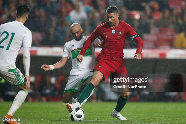 Portugal's forward Cristiano Ronaldo vies for the ball with Algelia's defender Mokhtar Benmoussa during the FIFA World Cup Russia 2018 preparation...