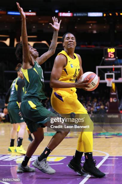 Jantel Lavender of the Los Angeles Sparks handles the ball against Natasha Howard of the Seattle Storm during a WNBA basketball game at Staples...