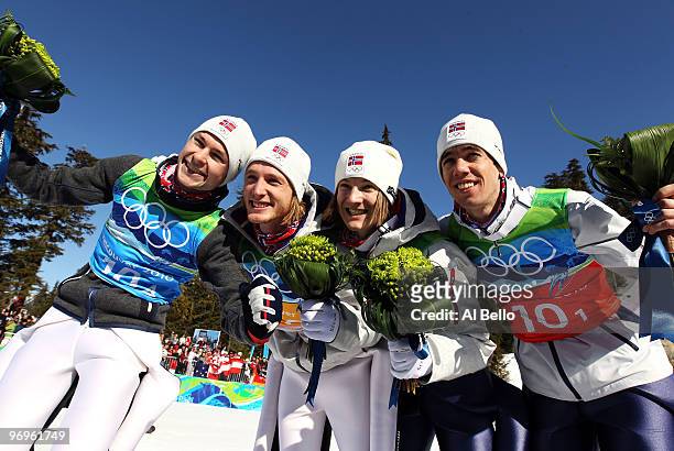 Anders Jacobsen, Johan Remen Evensen, Tom Hilde and Anders Bardal of Norway celebrate their bronze medal in the men's ski jumping team event on day...