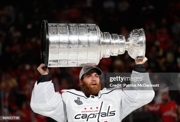 Braden Holtby of the Washington Capitals hoists the Stanley Cup after Game Five of the 2018 NHL Stanley Cup Final between the Washington Capitals and...