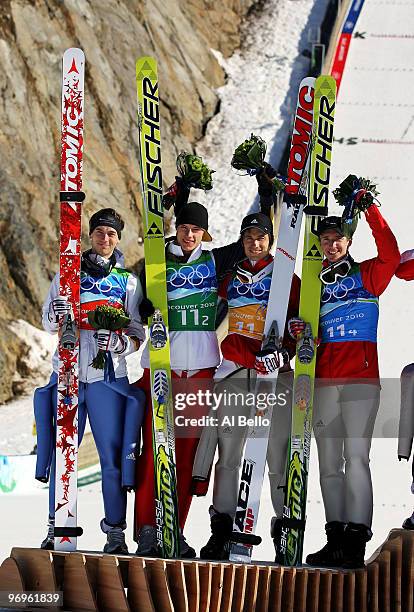 Michael Neumayer, Andreas Wank, Martin Schmitt and Michael Uhrmann of Germany celebrate their silver medal in the men's ski jumping team event on day...