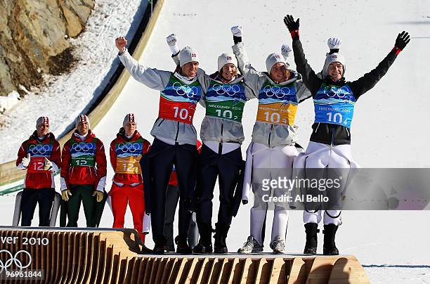 Anders Bardal, Tom Hilde, Johan Remen Evensen and Anders Jacobsen of Norway celebrate their bronze medal in the men's ski jumping team event on day...