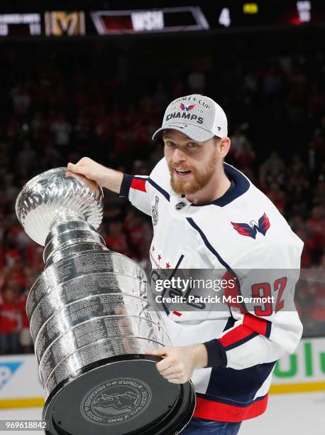 Evgeny Kuznetsov of the Washington Capitals holds the Stanley Cup after their team defeated the Vegas Golden Knights 4-3 in Game Five of the 2018 NHL...