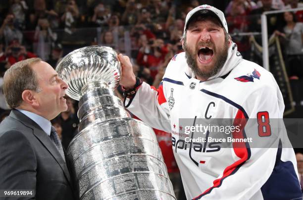 Alex Ovechkin of the Washington Capitals is presented the Stanley Cup by NHL Commissioner Gary Bettman after his team defeated the Vegas Golden...