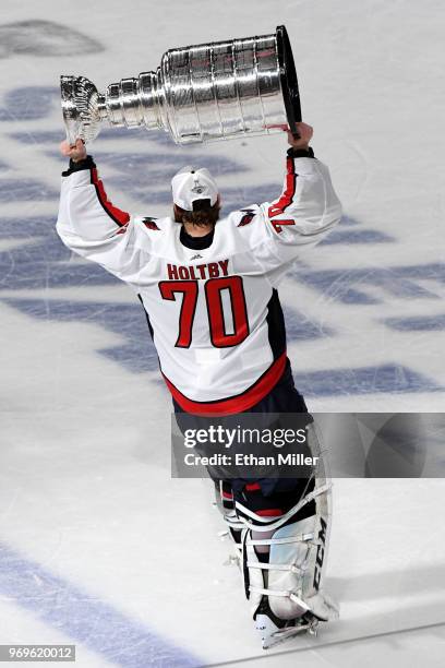 Braden Holtby of the Washington Capitals hoists the Stanley Cup after his team defeated the Vegas Golden Knights 4-3 in Game Five of the 2018 NHL...