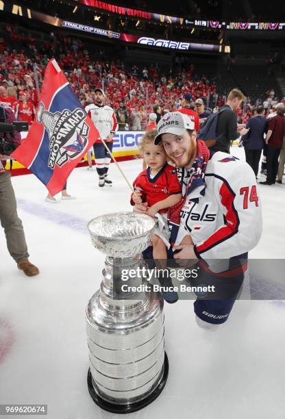 John Carlson of the Washington Capitals poses with his child and the Stanley Cup after their team defeated the Vegas Golden Knights 4-3 in Game Five...