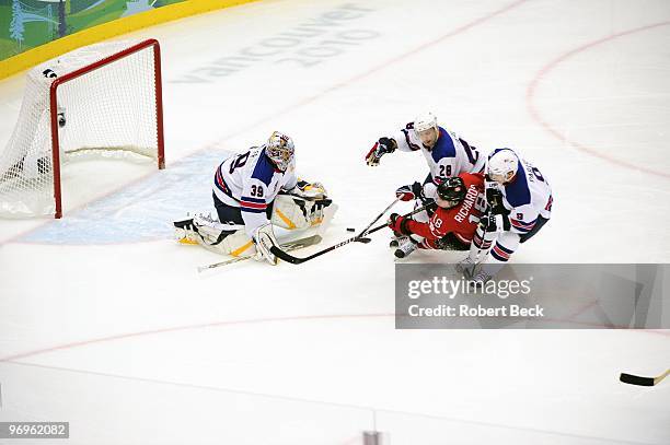 Winter Olympics: USA Brian Rafalski , Zach Parise , and goalie Ryan Miller in action, defense vs Canada Mike Richards during Men's Preliminary Round...