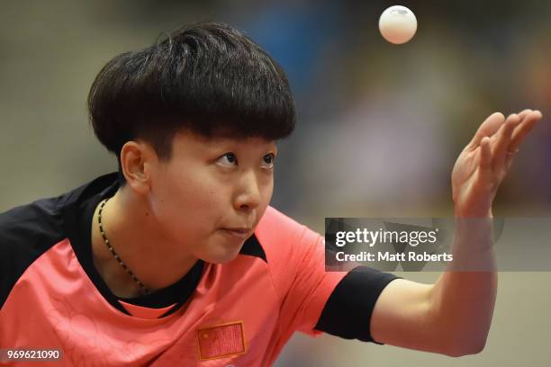 Mi Zi of China competes against Tianwei Feng of Singapore during the women's singles round one match on day one of the ITTF World Tour LION Japan...