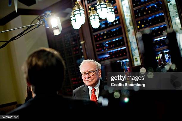 Warren Buffett, chief executive officer of Berkshire Hathaway, speaks during a television interview in advance of a charity lunch with a group led by...