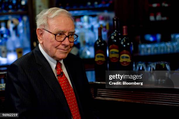 Warren Buffett, chief executive officer of Berkshire Hathaway, speaks during a television interview in advance of a charity lunch with a group led by...